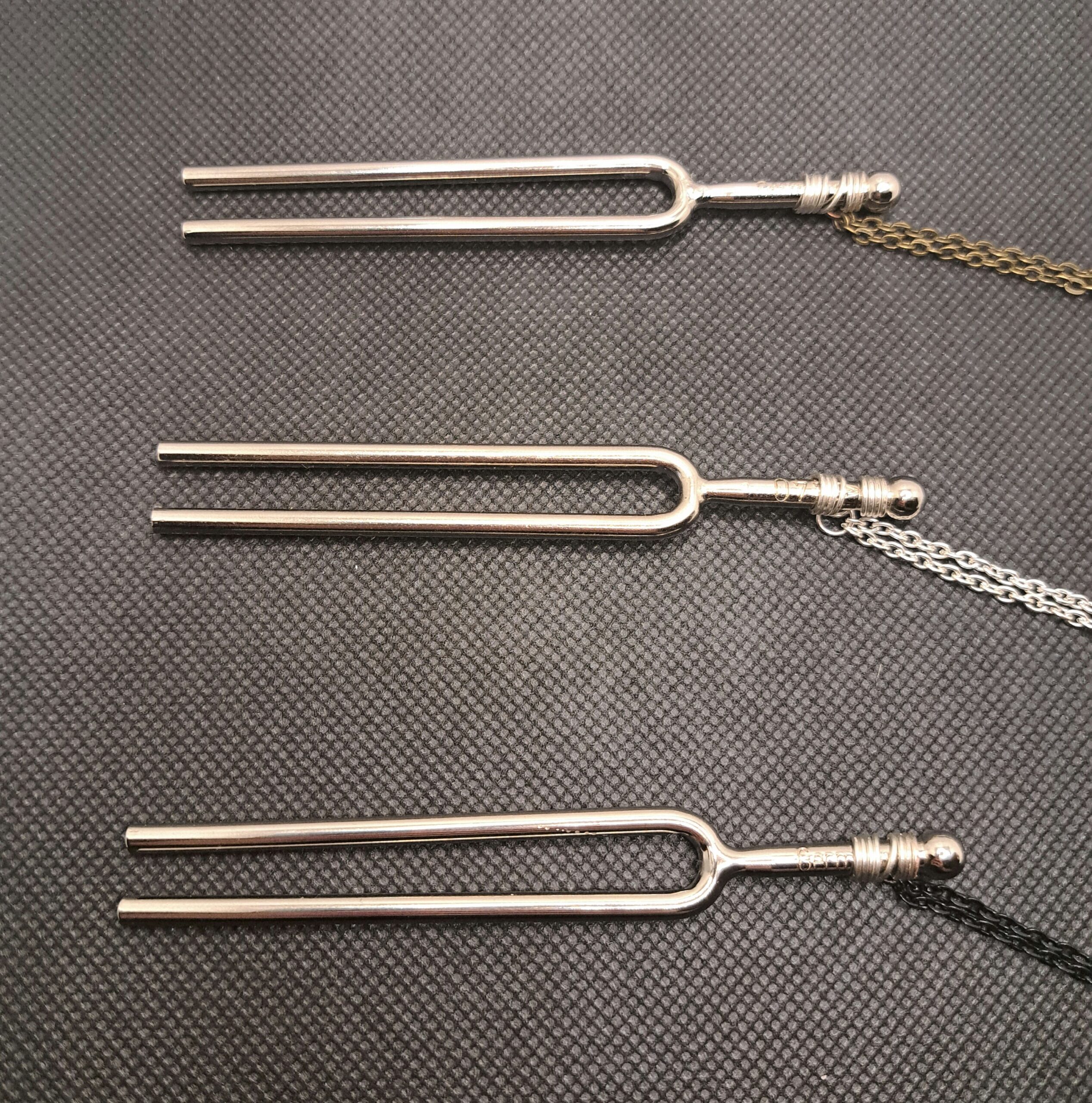 Tuning fork necklaces with bronze, silver, and black chains